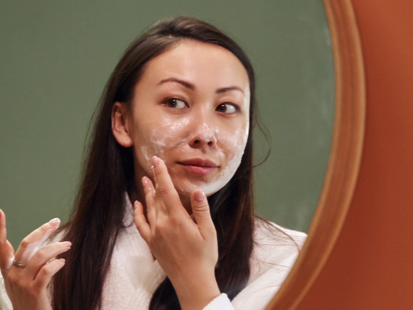 woman using face exfoliant