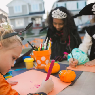 Kids in Halloween costumes coloring