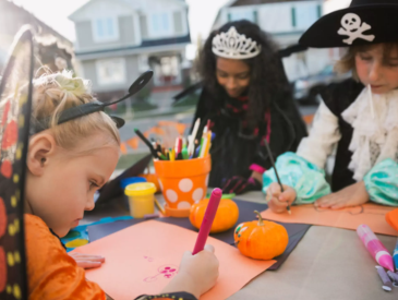 Kids in Halloween costumes coloring